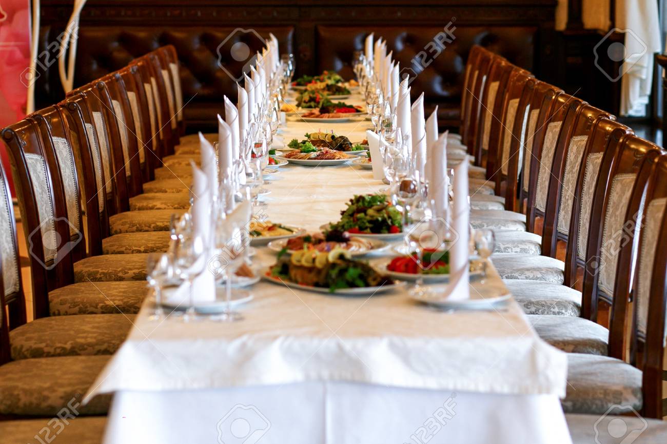 stylish table with food and drinks setting for guests at elegant  wedding reception, catering in restaurant